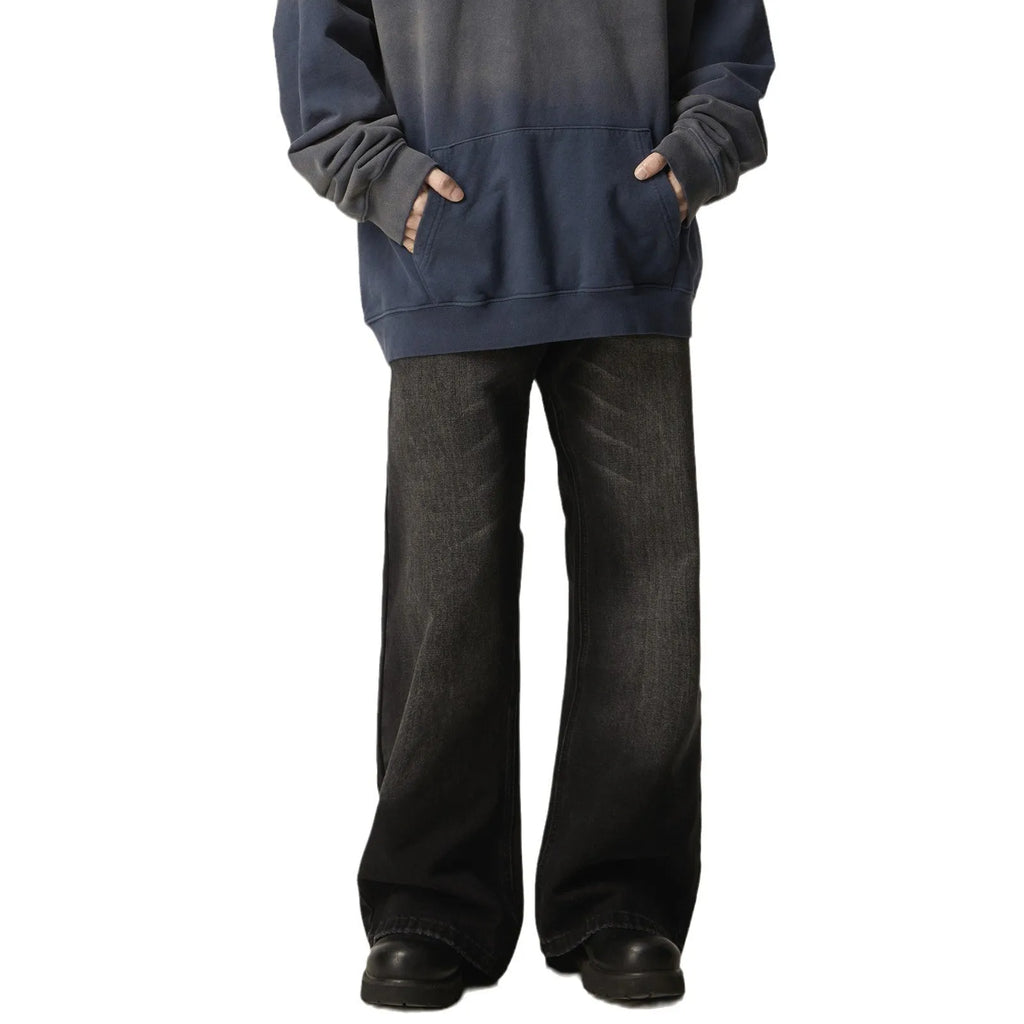 Black loose fit straight leg retro jeans on a hanger, showing zipper fly and relaxed silhouette.