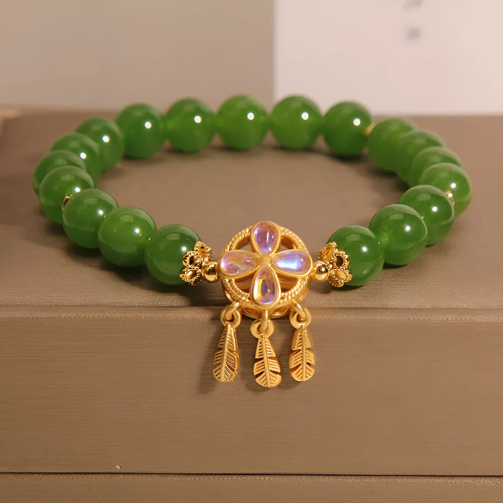 Green Jasper Crystal four-leaf clover dreamcatcher pendant on a women's bracelet.