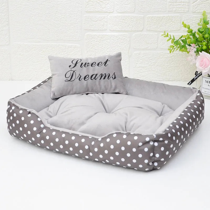 Polka dot printed cloth dog bed with matching embroidery pillow for a small dog.