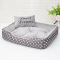 Polka dot printed cloth dog bed with matching embroidery pillow for a small dog.