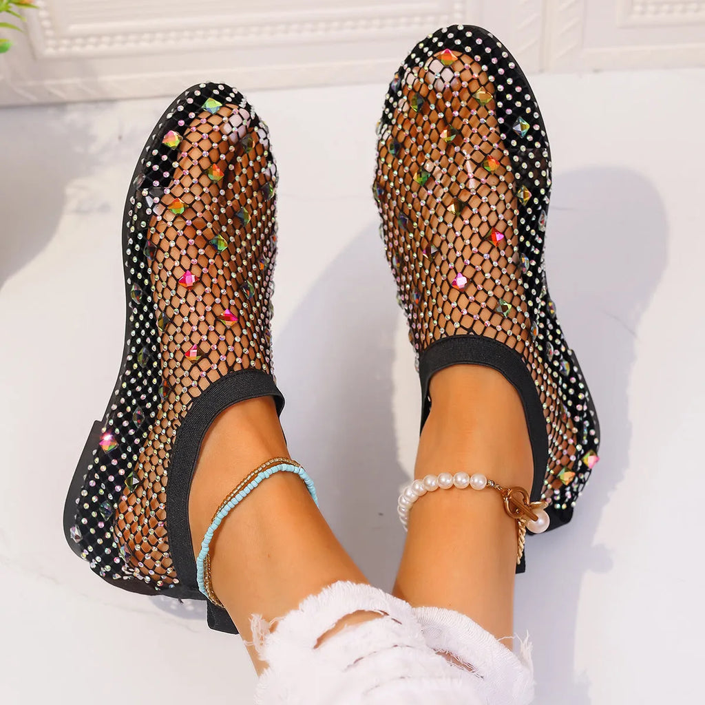 Women's flat sandals with mesh upper, colourful rhinestone detail, and a round toe.