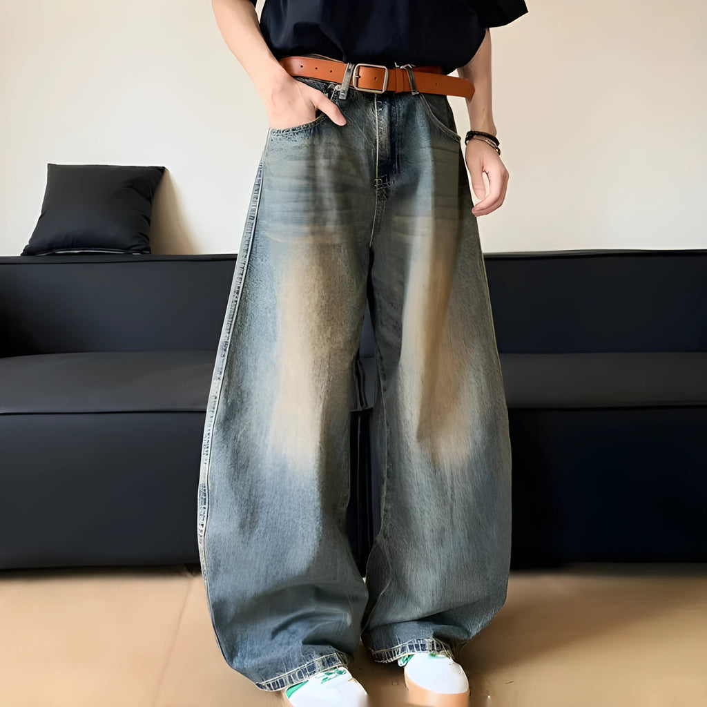 Men's distressed retro blue denim trousers with wide-leg silhouette and micro-elastic cotton-blend fabric