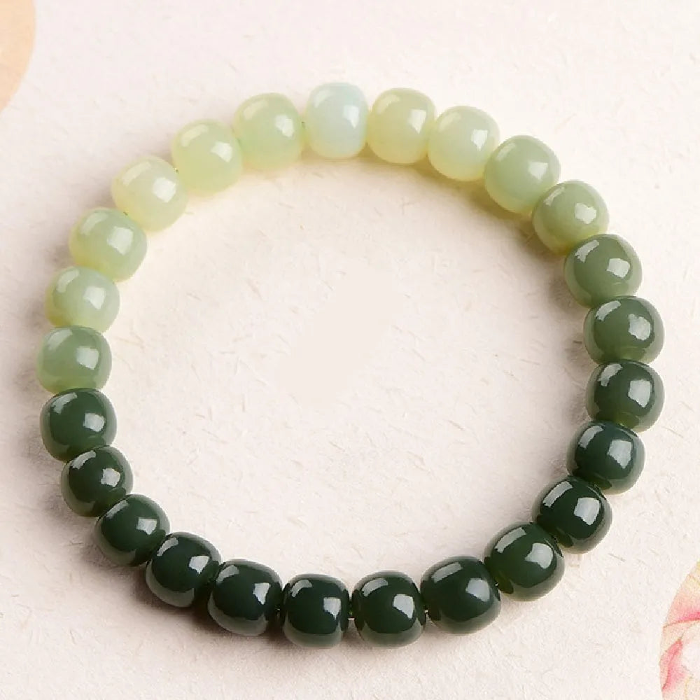 Natural Hetian jade bracelet with water gradient colours on wrist.