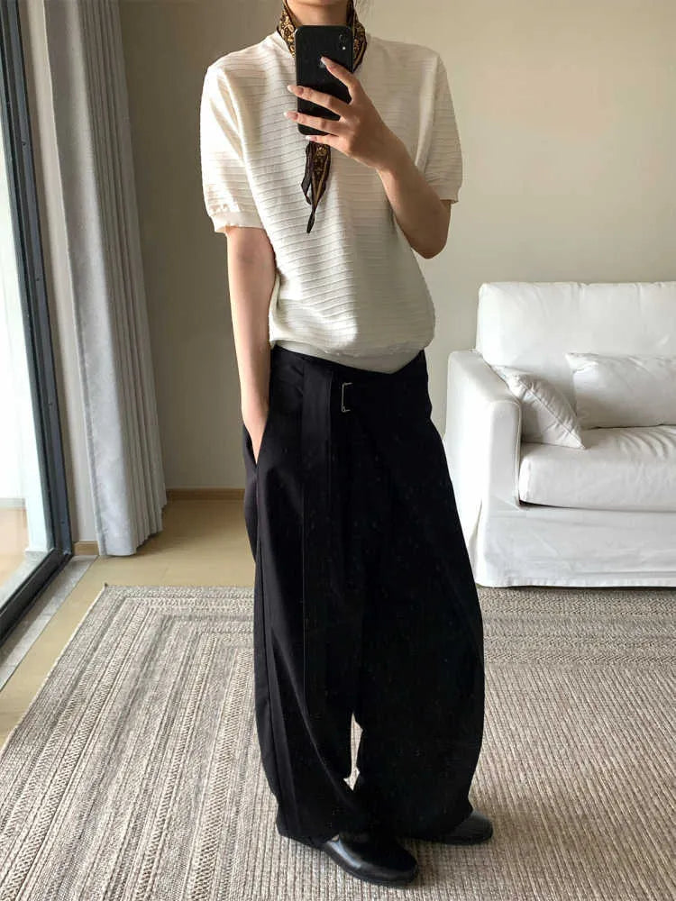 Black straight-leg trousers with a single pleat and adjustable waistband on a plain background.