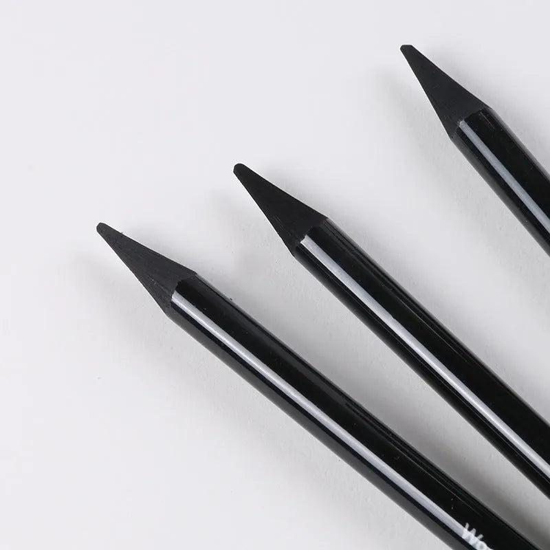 Set of nine art pencils on a card: six graphite pencils and three darker carbonized pencils in wooden casings.
