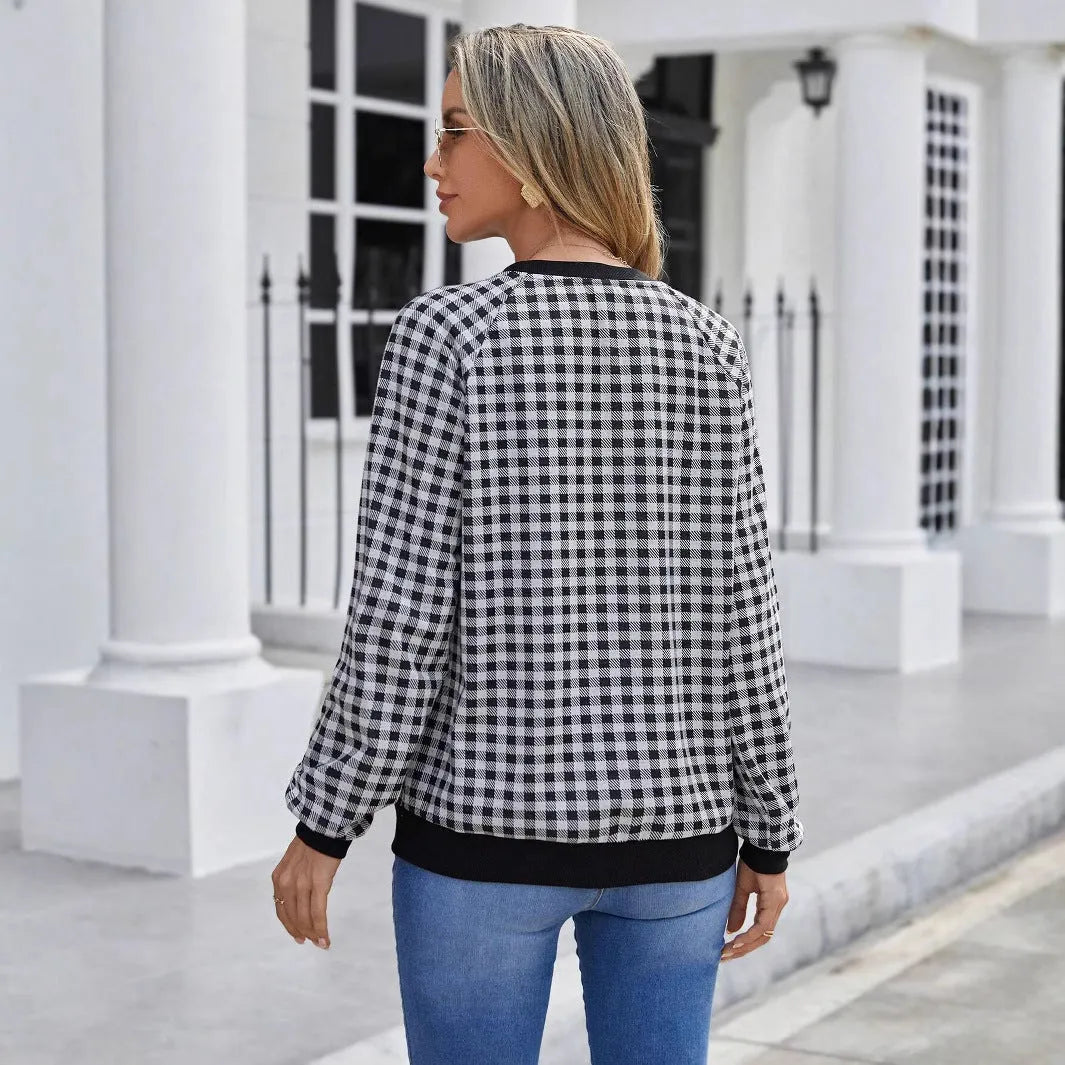 Black long sleeve plaid pullover sweater with Japanese style printing laid flat.