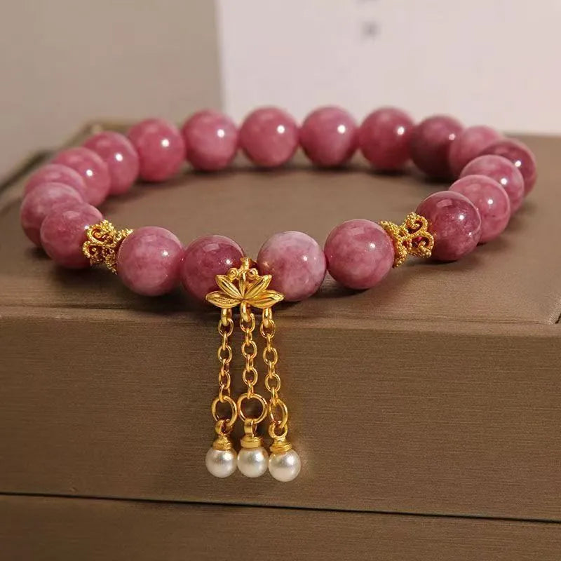 Pink lotus and pink white crystal natural stone bracelet with pearl pendant and lotus tassel in new Chinese style.