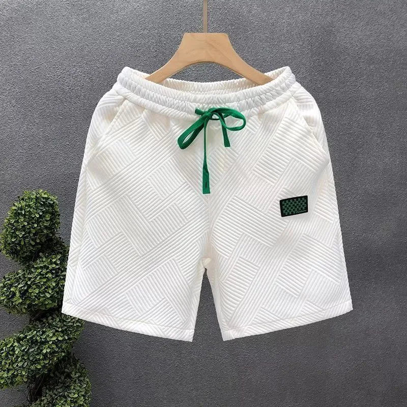 Solid colour polyester sports shorts with elastic waist on a mannequin, shown in black.