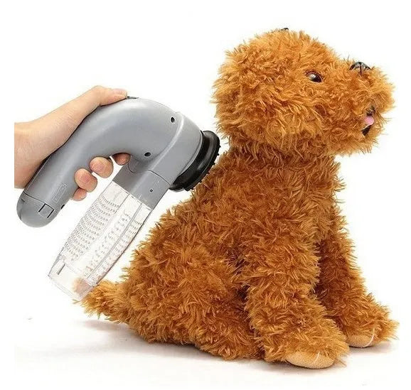 Grey handheld pet hair vacuum cleaner with soft rubber brush head for grooming dogs and cats.
