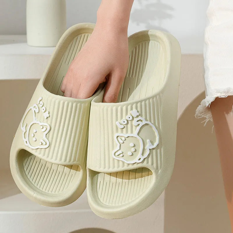 Women's cat platform slippers in pink with thick EVA sole, shown on a wooden floor.