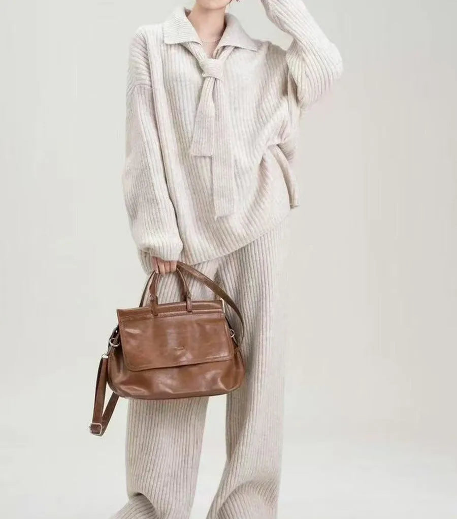 Women's dark grey knit top and trousers two-piece sweater suit set on a hanger