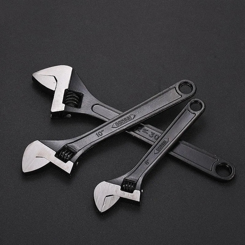 High-carbon steel adjustable spanner with black finish on a grey background.