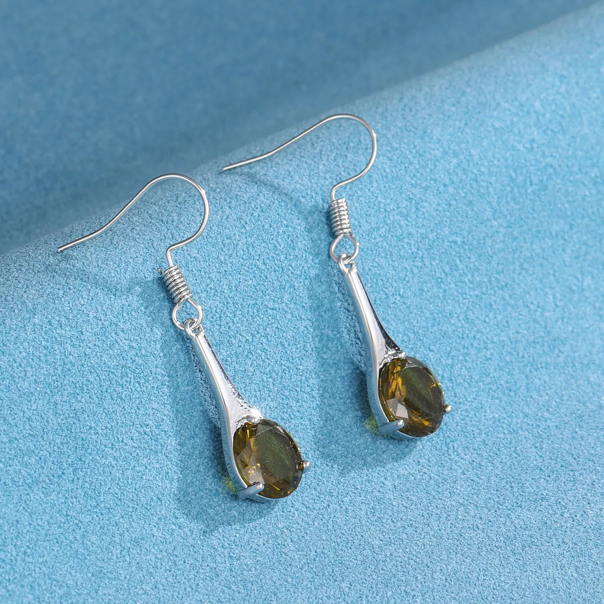Women's olive green topaz coloured drop earrings with a simple water drop shape and retro style.