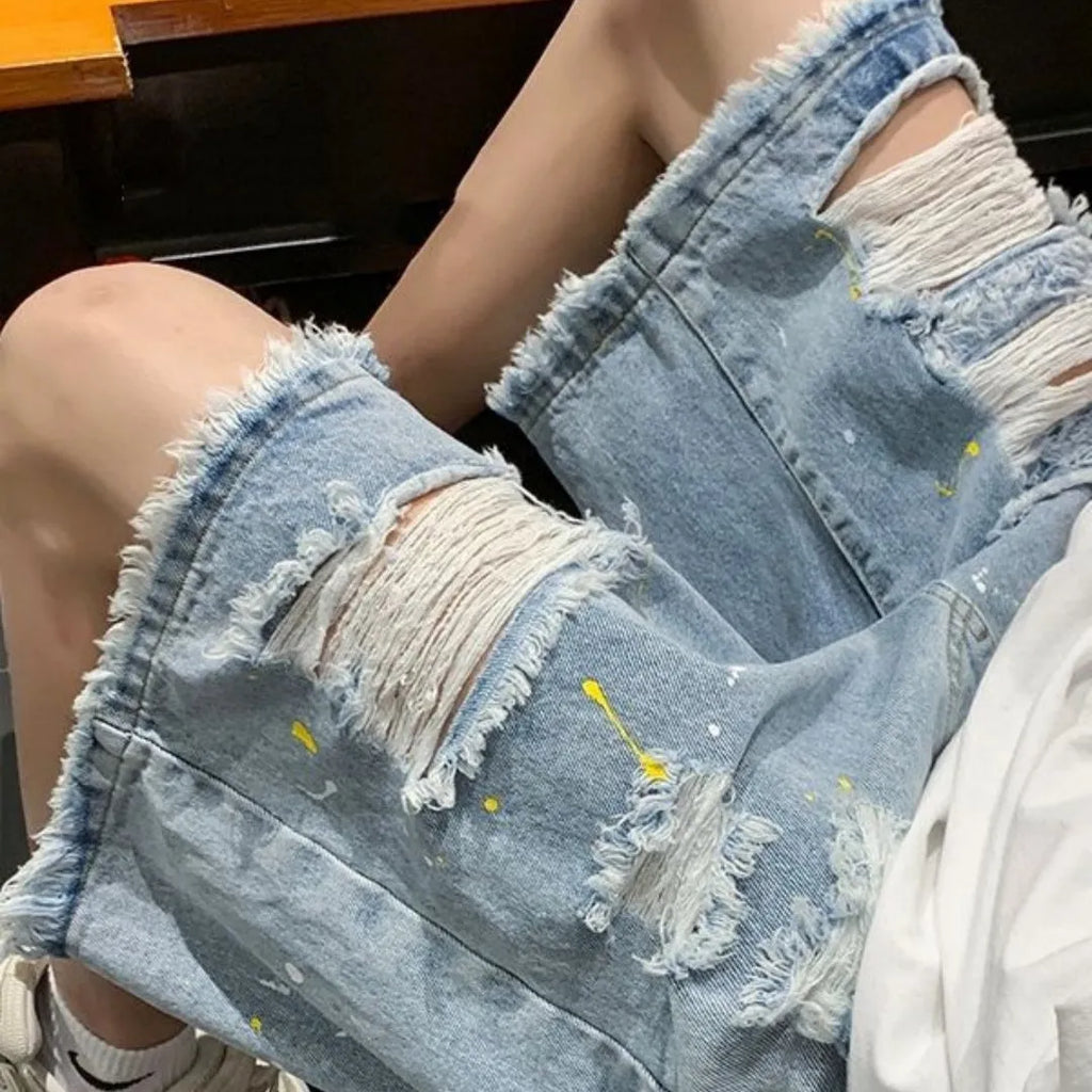 Men's loose-fit denim shorts with water-washed finish and distressed hole detailing in black colour