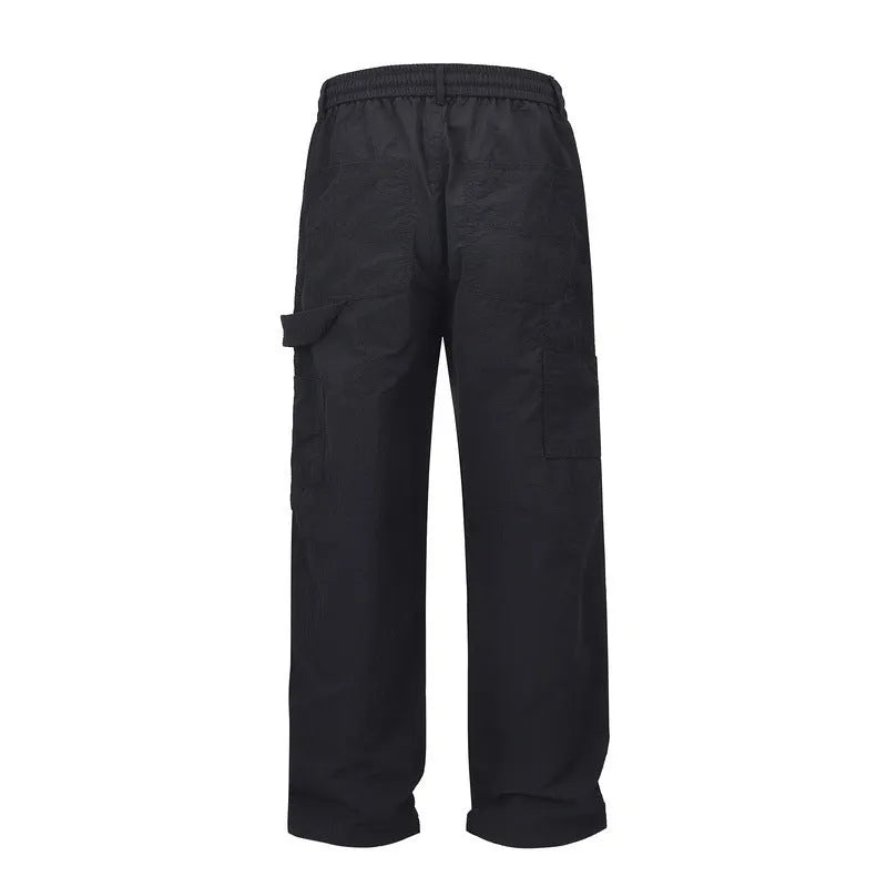 Black baggy paratrooper pants with an elastic drawstring waistband on a mannequin.