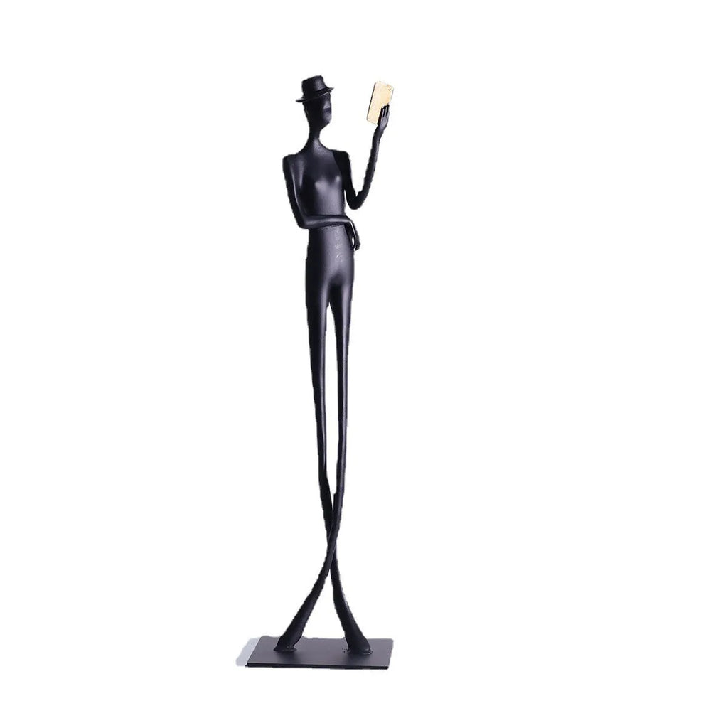 Black aluminium desktop sculpture of a woman reading, modern style.