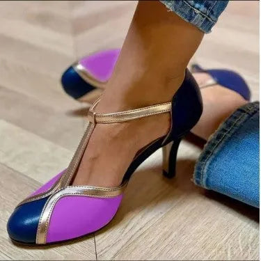 Women's round toe high heel shoe in light blue pink with a button closure, shown on a white background.