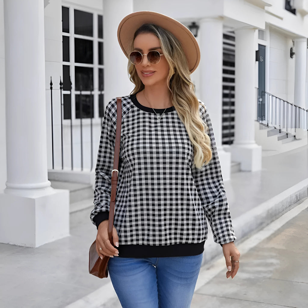 Black long sleeve plaid pullover sweater with Japanese style printing laid flat.