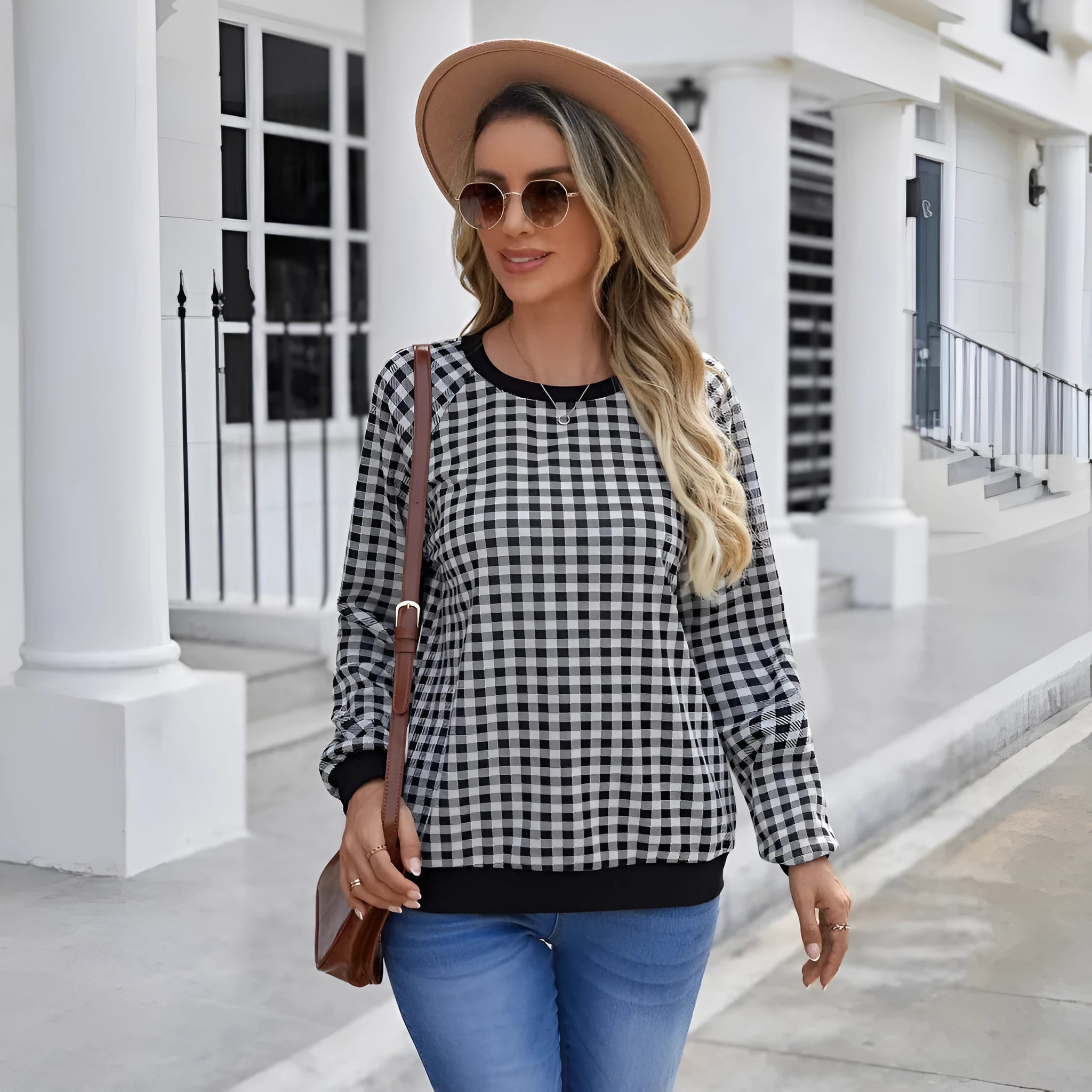 Black long sleeve plaid pullover sweater with Japanese style printing laid flat.