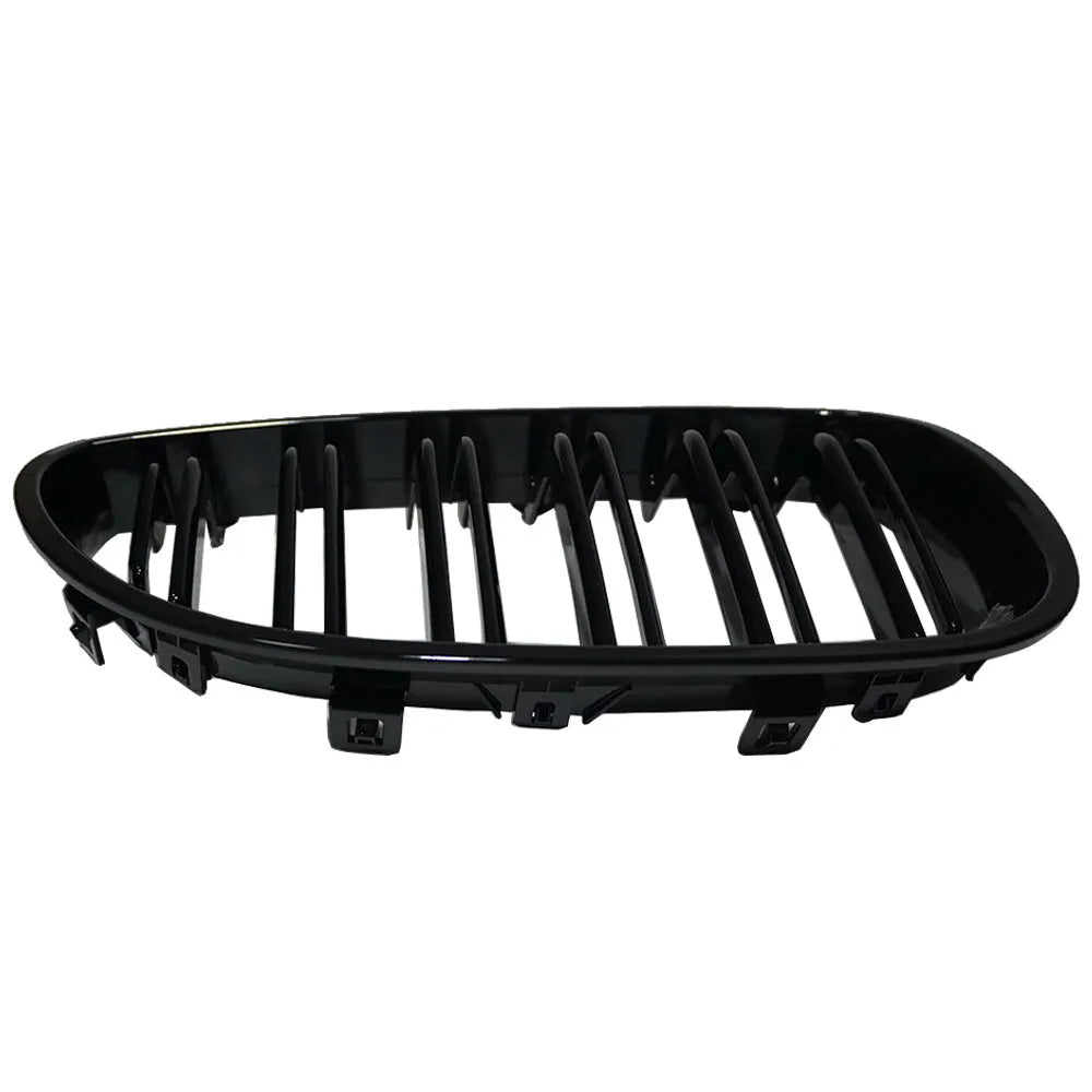 Pair of black carbon fibre pattern front grilles for a BMW 5-Series car.
