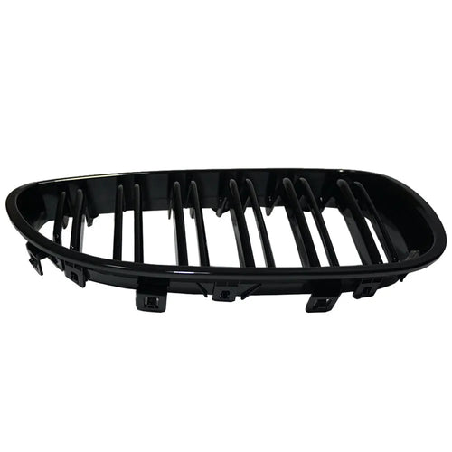 Pair of black carbon fibre pattern front grilles for a BMW 5-Series car.