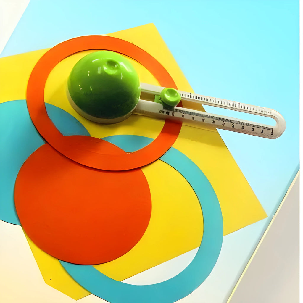 Orange or green plastic round paper cutter for A3 sheets on a colour box.