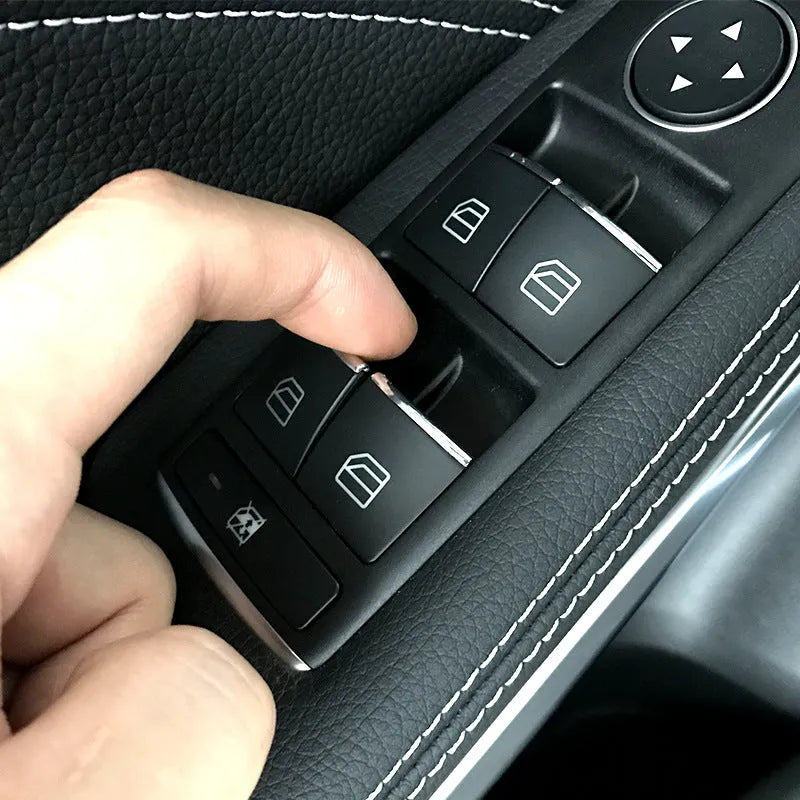 Black glitter decorative sticker for car window lift button modification on a dark background.