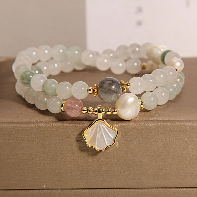 Women's crystal bracelet with a gold-plated ginkgo leaf pendant and rhinestone details.