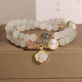 Women's crystal bracelet with a gold-plated ginkgo leaf pendant and rhinestone details.