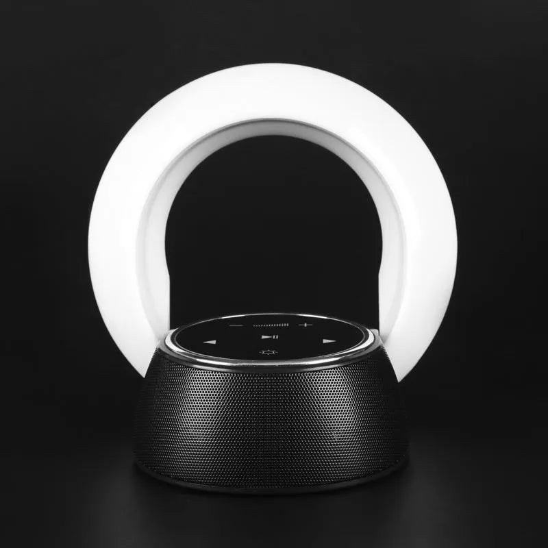 Blue cubic Bluetooth desk lamp speaker with touch controls and folding head on wooden desk