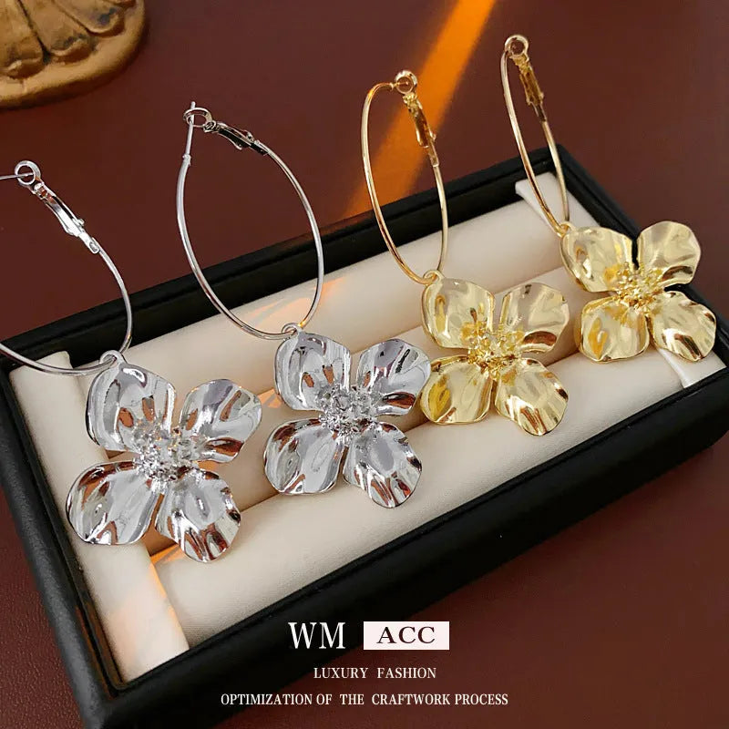 Flower and geometric design metal earrings in gold or silver electroplated finish with silver needle posts