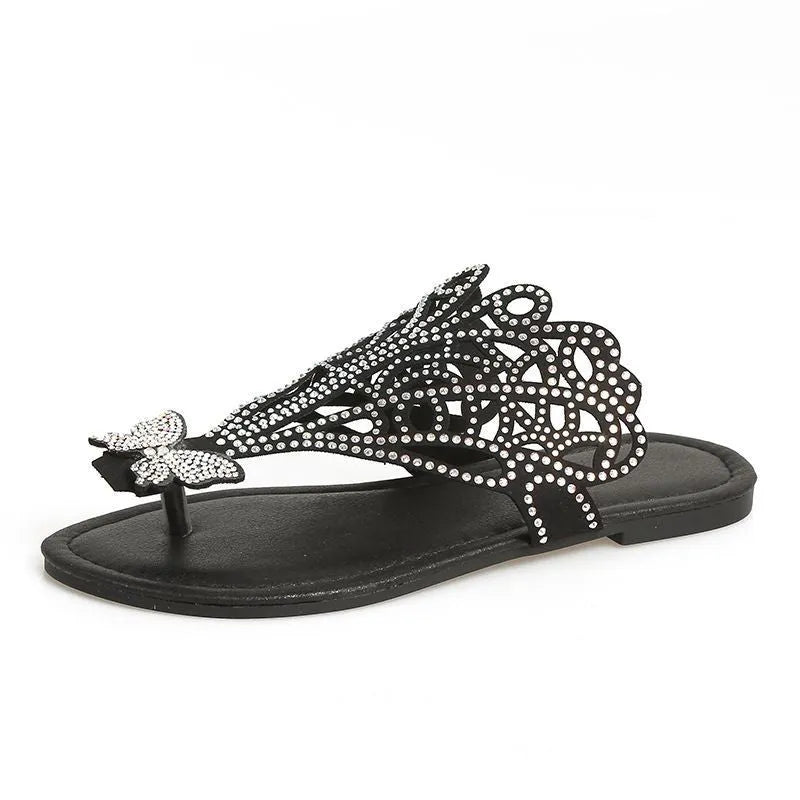 Women's black slip-on sandals with gold rhinestone decoration on the toe strap
