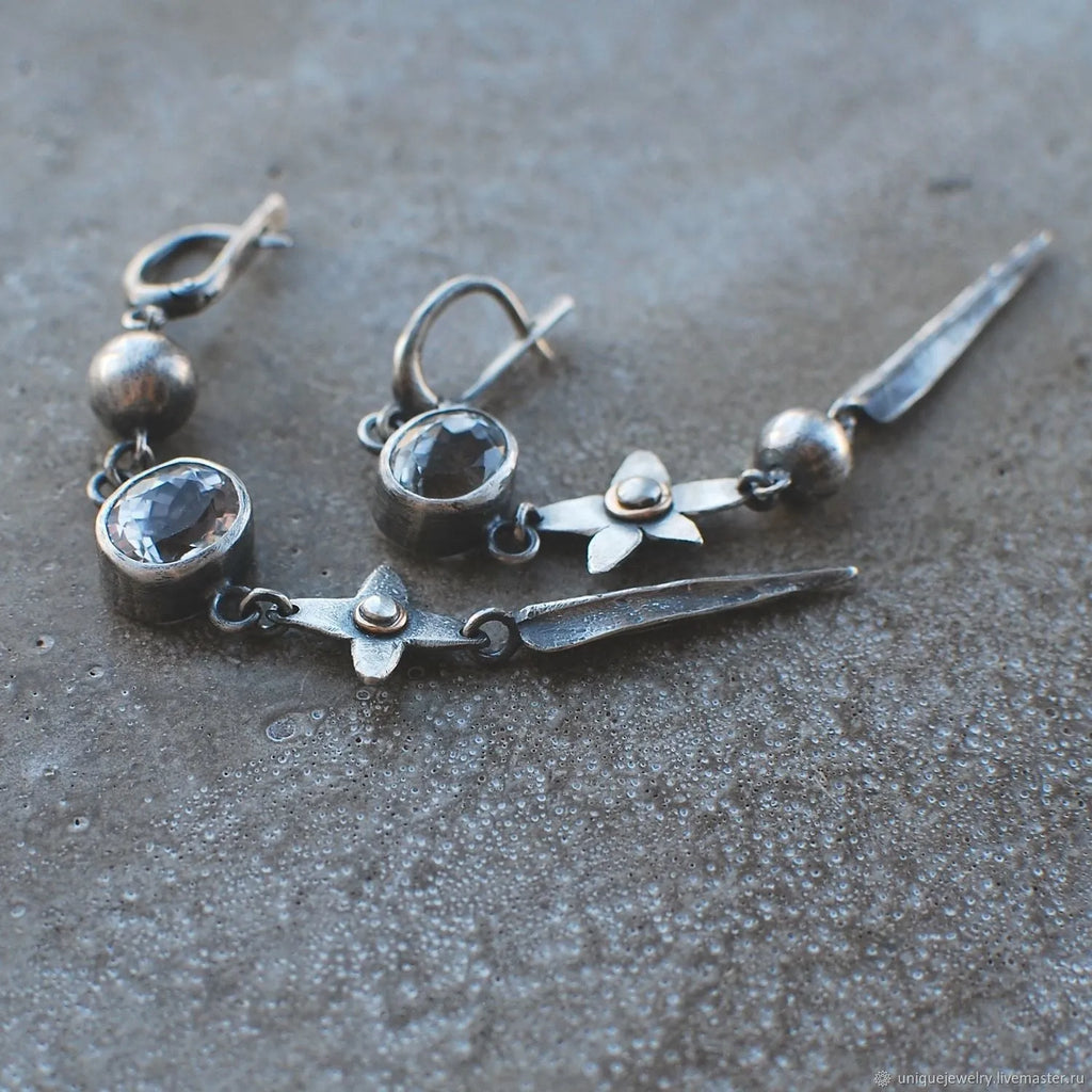 Geometric XINGX pendant earrings with antique silver finish and rhinestone detailing