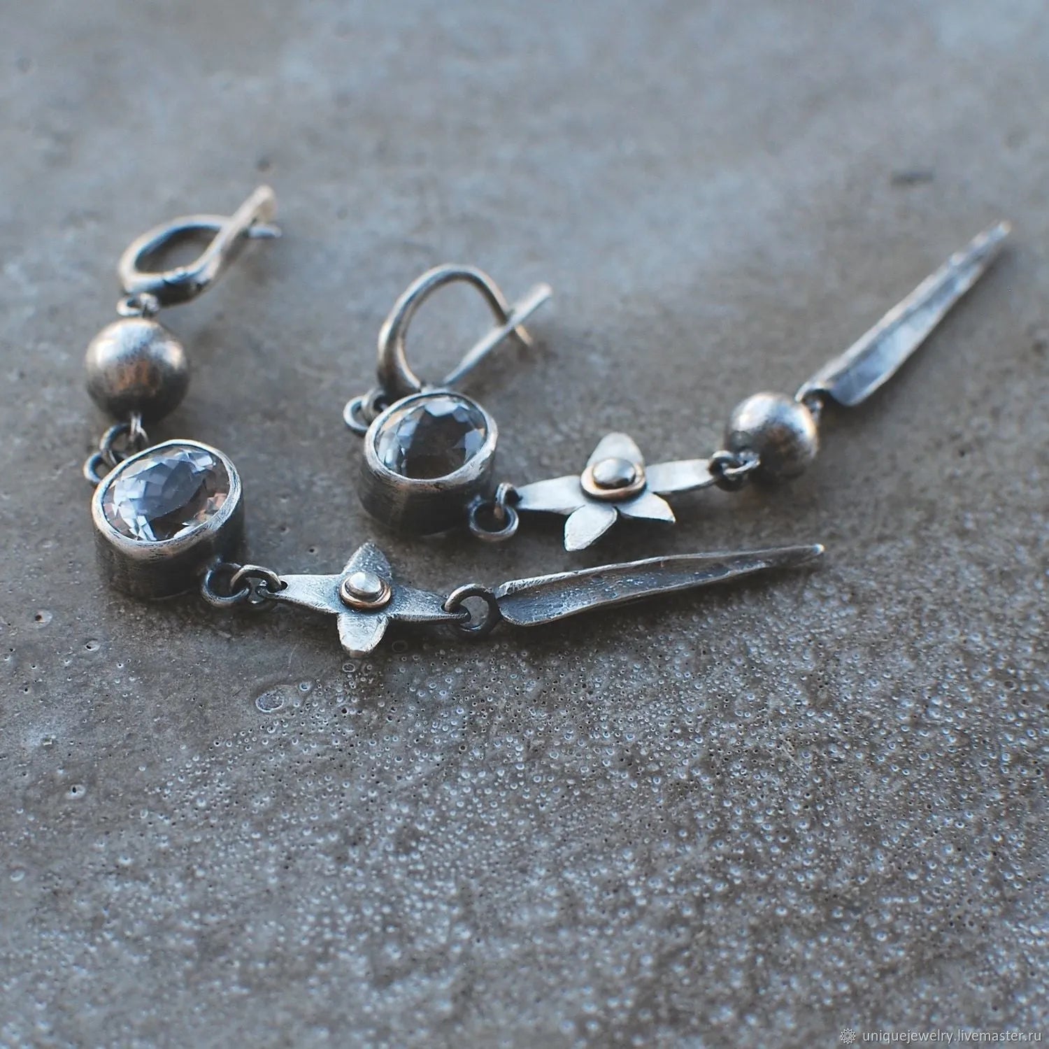 Geometric XINGX pendant earrings with antique silver finish and rhinestone detailing