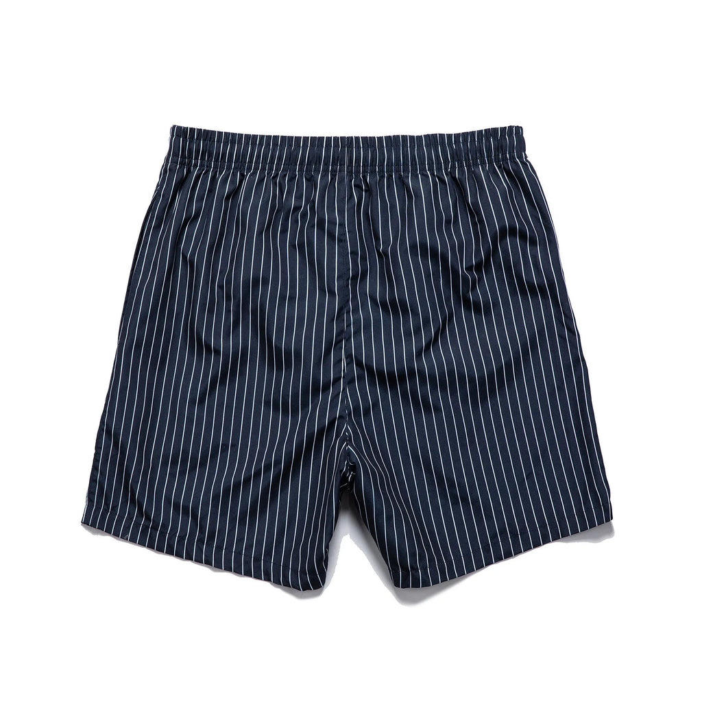 Navy blue striped beach shorts with straight legs on a mannequin.