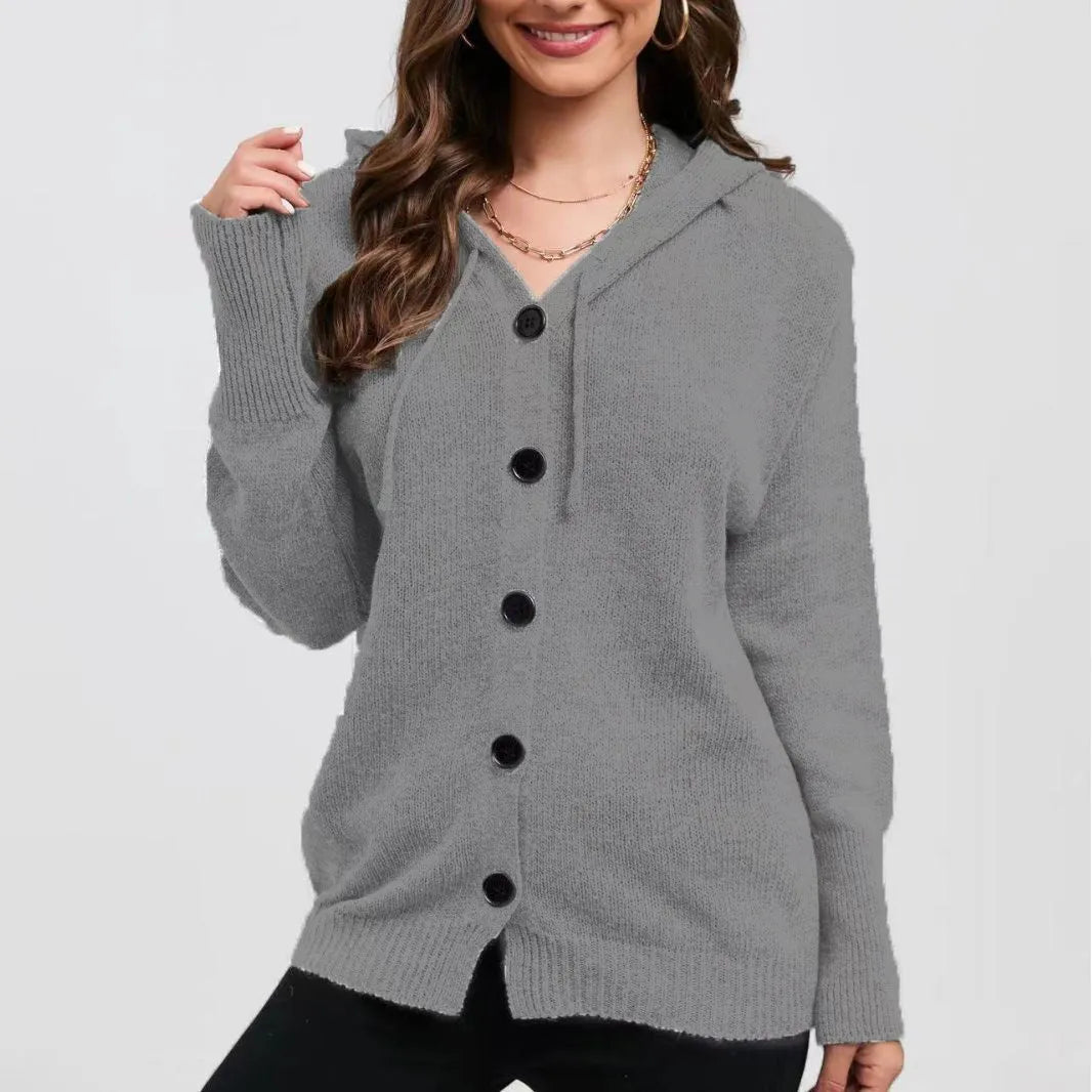A woman wearing a loose-fit, hooded, solid-colour cotton cardigan sweater in a neutral tone.