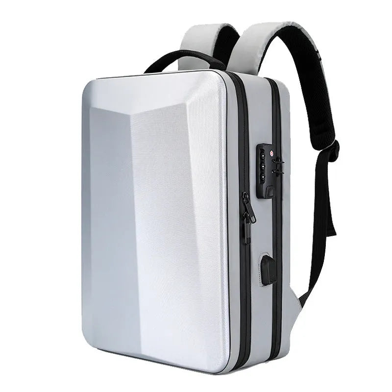 Black waterproof ABS PC business backpack with a curved shoulder strap, shown next to a laptop.