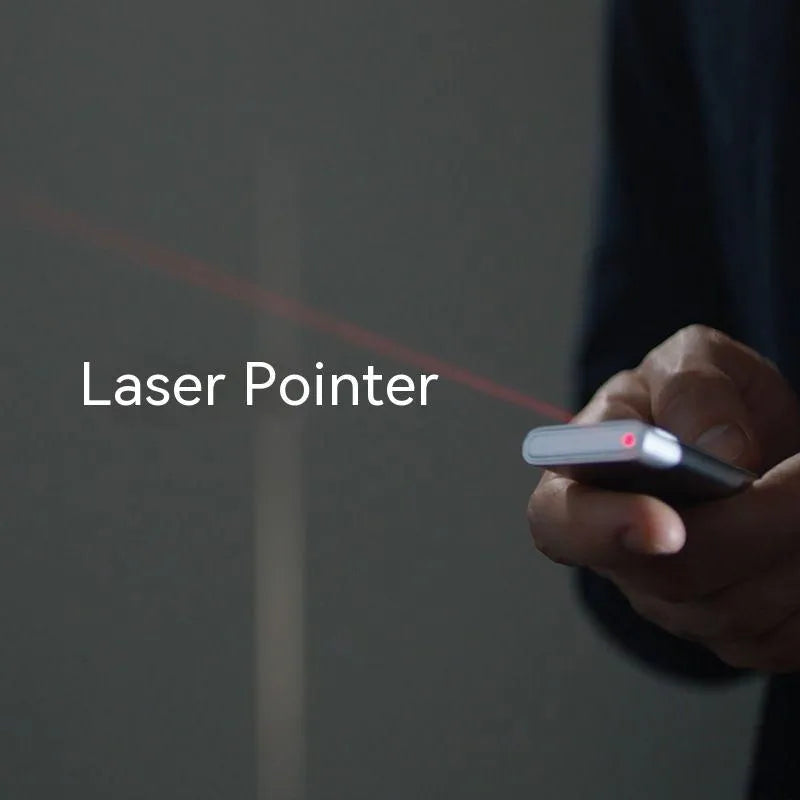 Silver wireless presenter with laser pointer and remote control on table