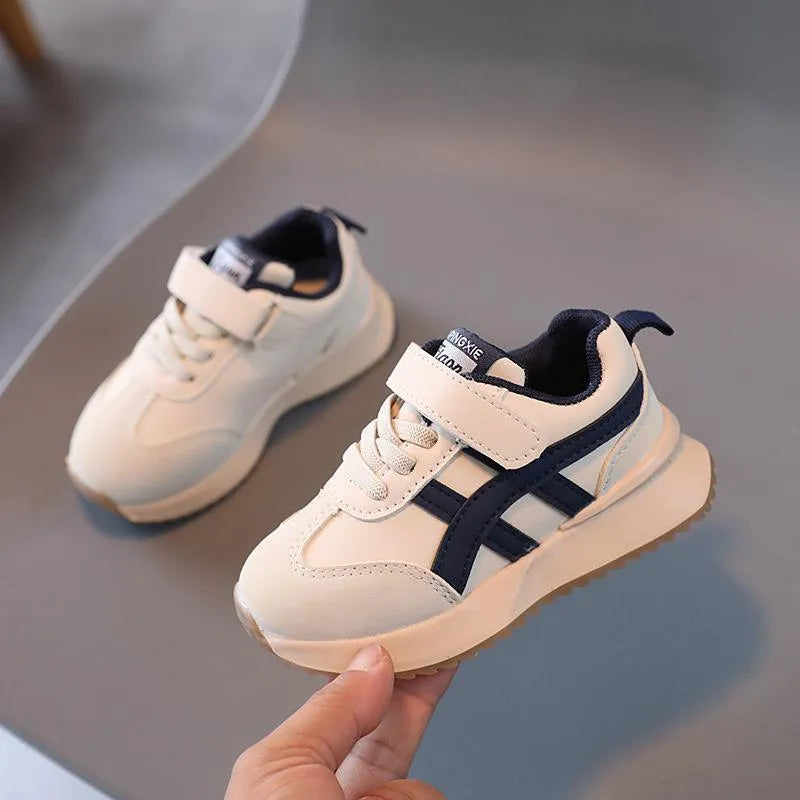 Children's white casual sneaker with Velcro fastening and rubber sole shown on size label.