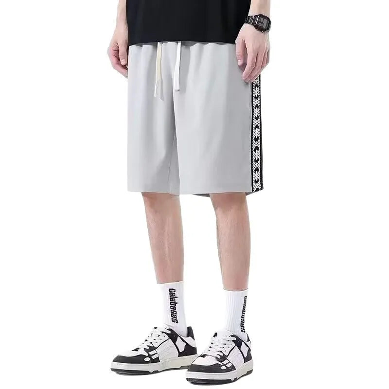 Men's black loose-fit baggy track pants with micro-elasticity fabric and sport styling