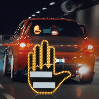 Black plastic LED car gesture light showing illuminated middle finger sign on dashboard