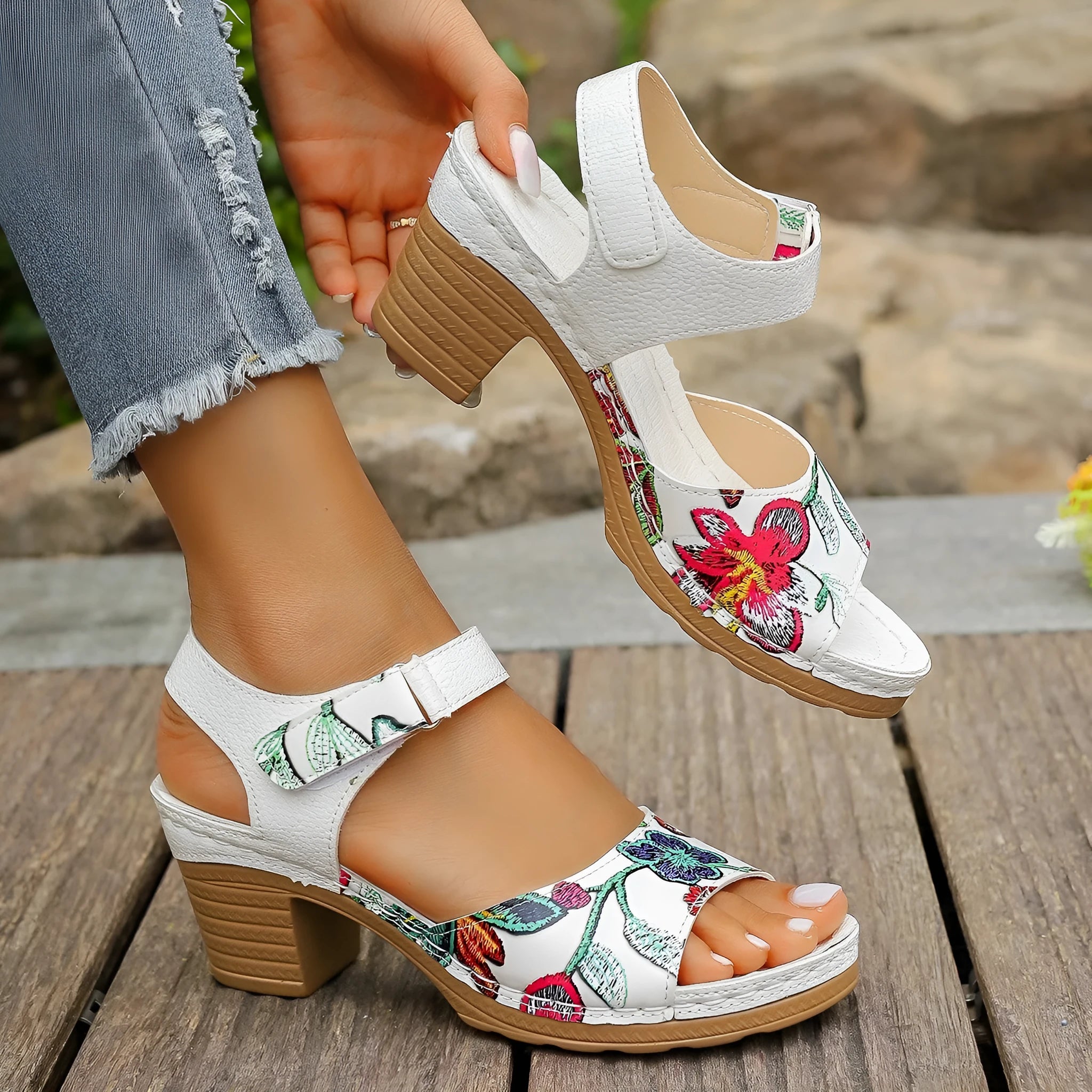 White women's high heel sandals with a Velcro strap buckle on a rubber sole.