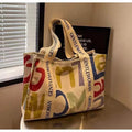 Canvas tote bag with printed design options including black letters, coloured letters, and pattern styles