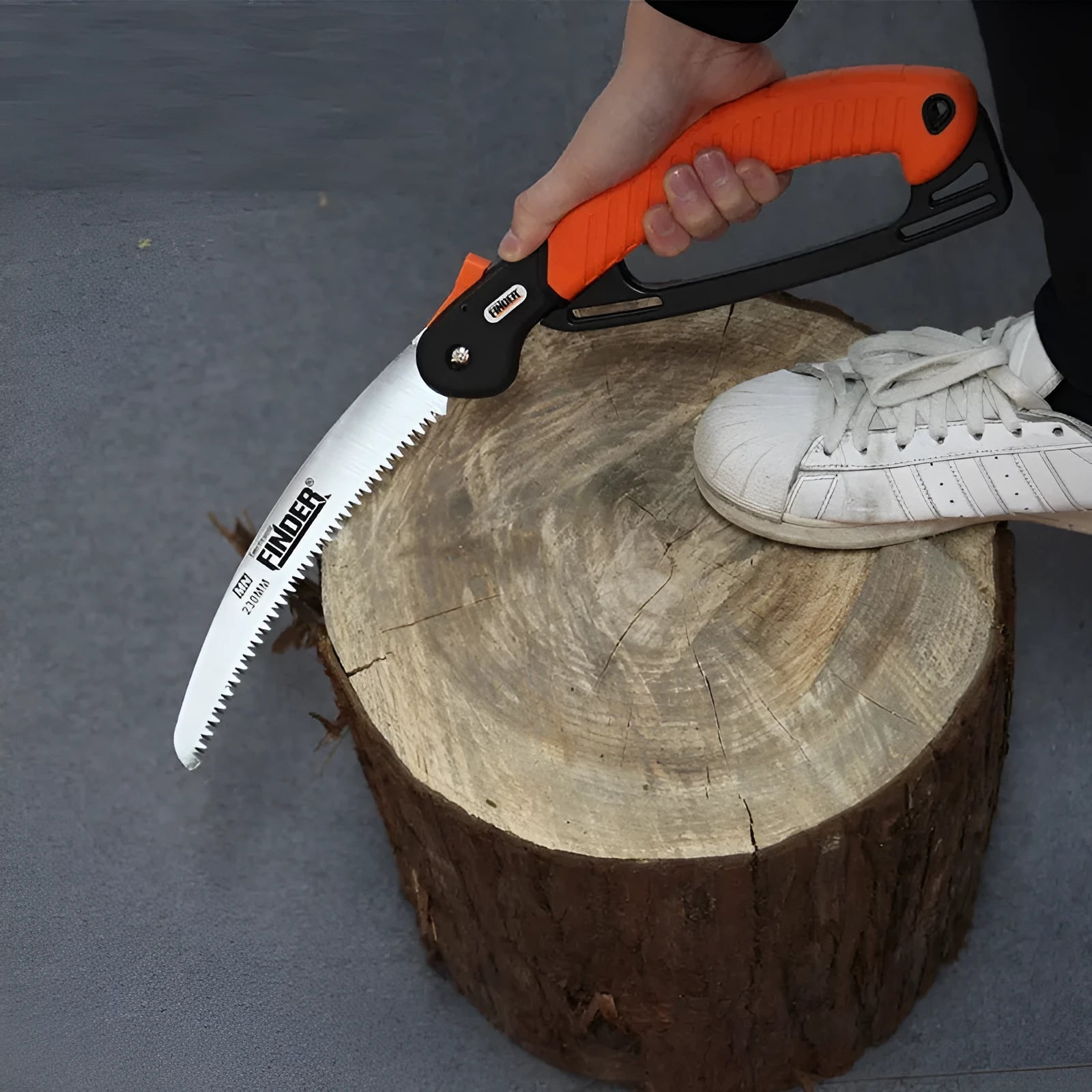 Garden folding hand saw with extended 230mm blade showing TPR grip and 65MN steel construction