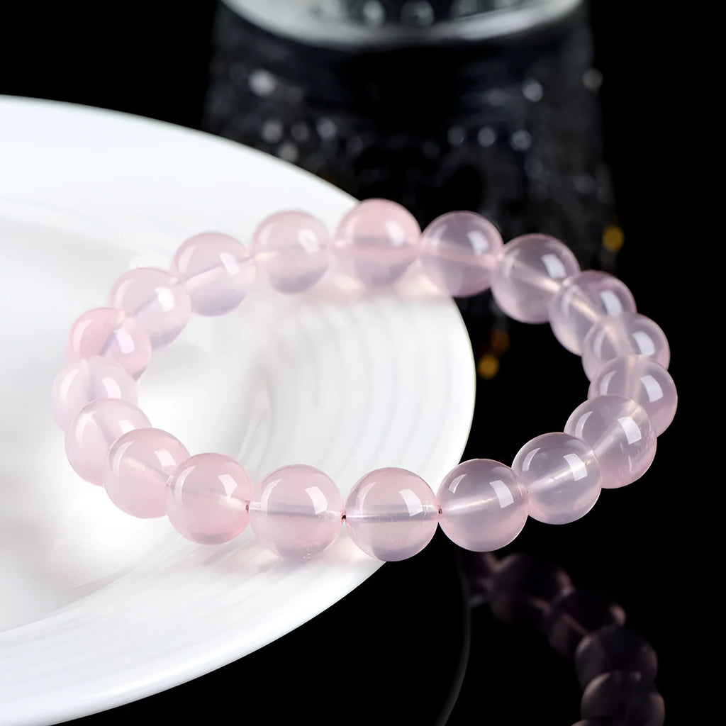 Natural starlight crystal round bead bracelet in pink, shown in a single circle design with polished beads.
