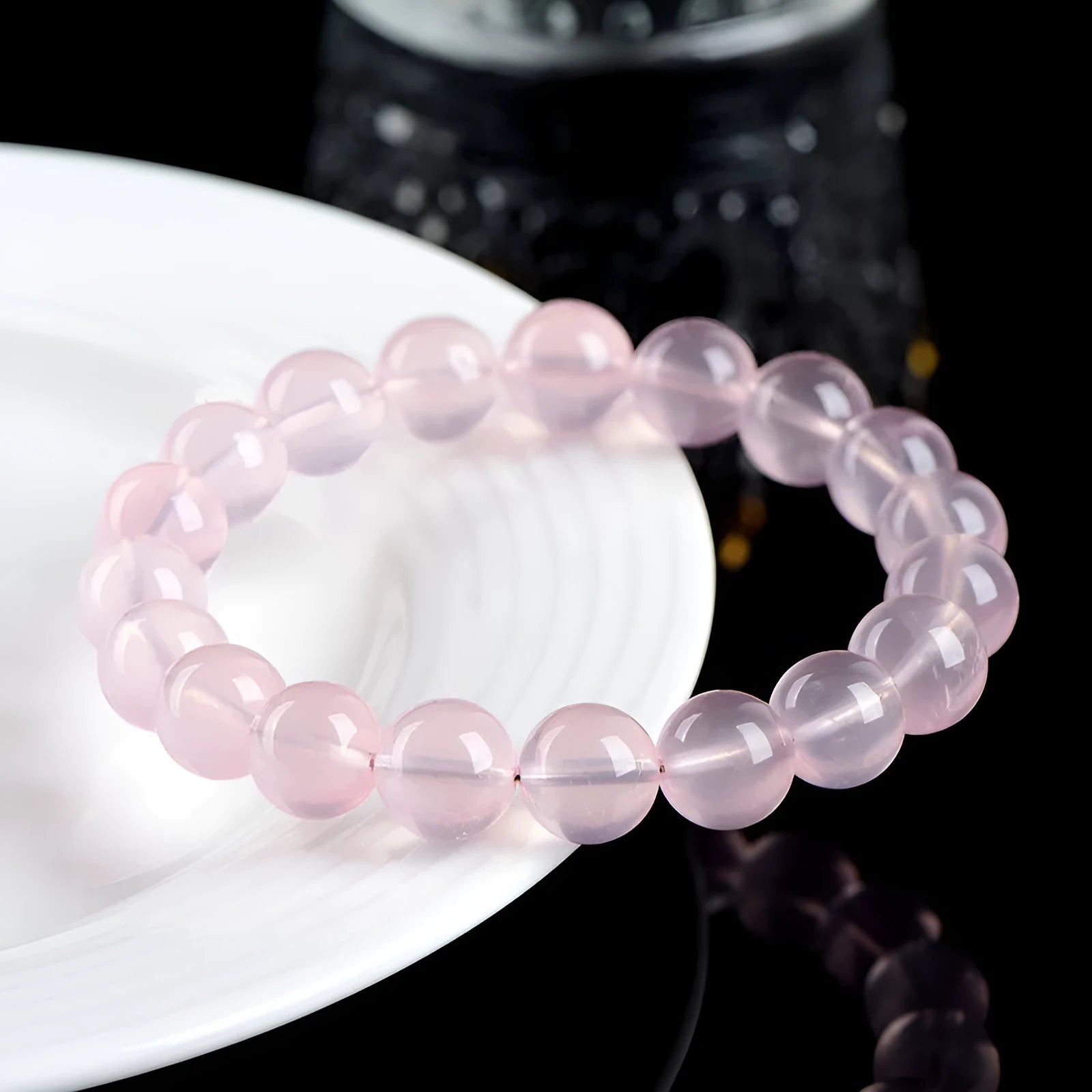 Natural starlight crystal round bead bracelet in pink, shown in a single circle design with polished beads.