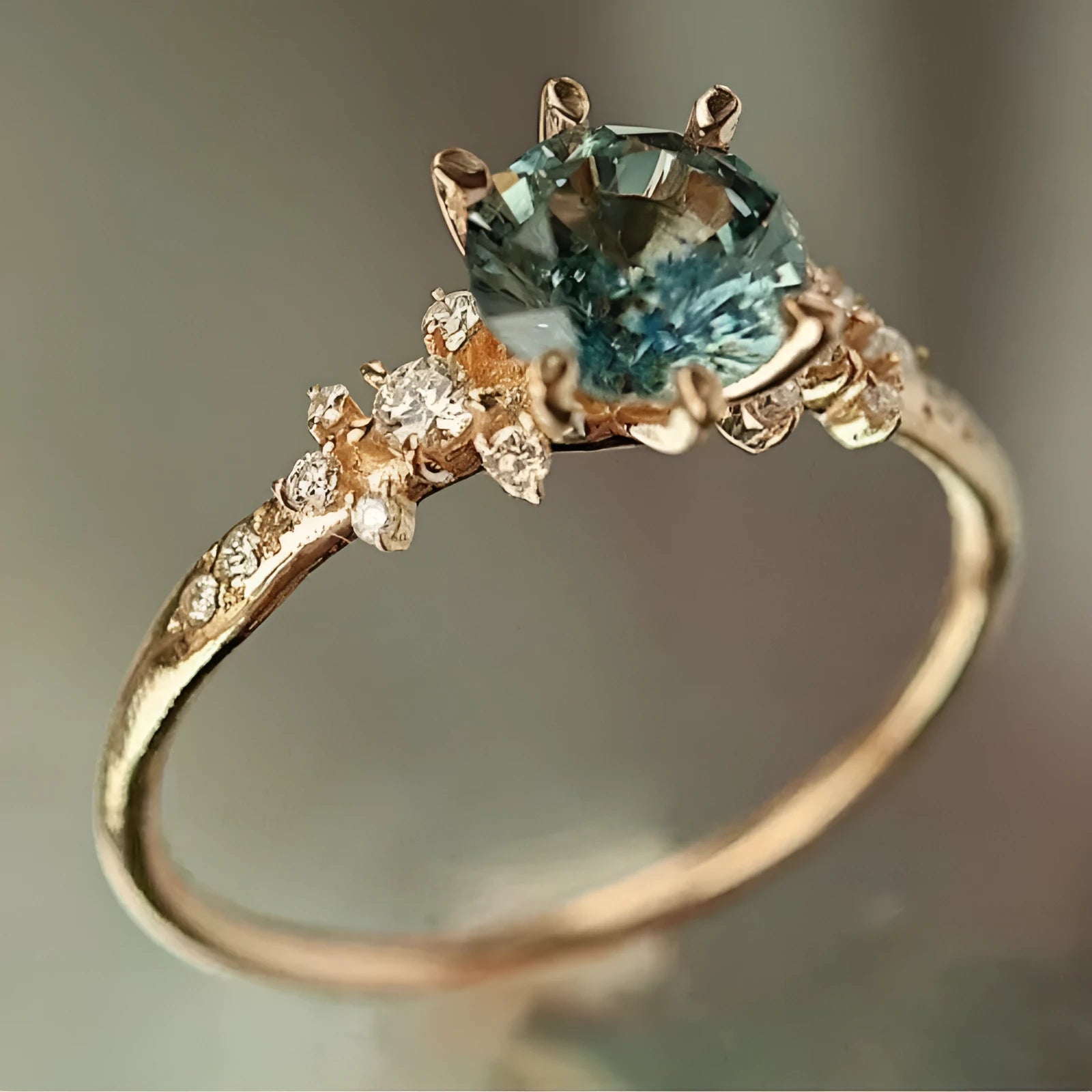 Gold plated geometric ring with claw-set zircon stone and chamfered square pattern design
