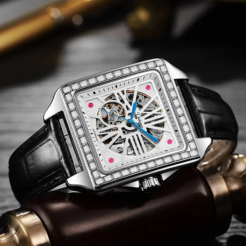 Men's square-faced automatic watch with diamond detailing on a stainless steel bracelet