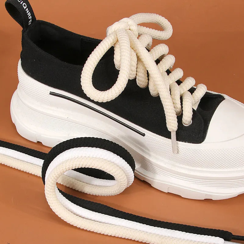 Round white woven shoelace on a grey background showing its 10mm diameter and textured weave.