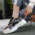 Women's white casual sports shoes with mesh upper, thick PU sole, buckle detail, and round toe.